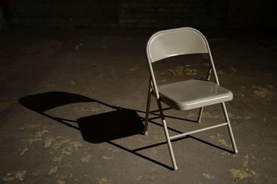 High angle view of empty chair on table