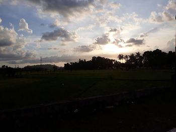 Scenic view of field against sky during sunset