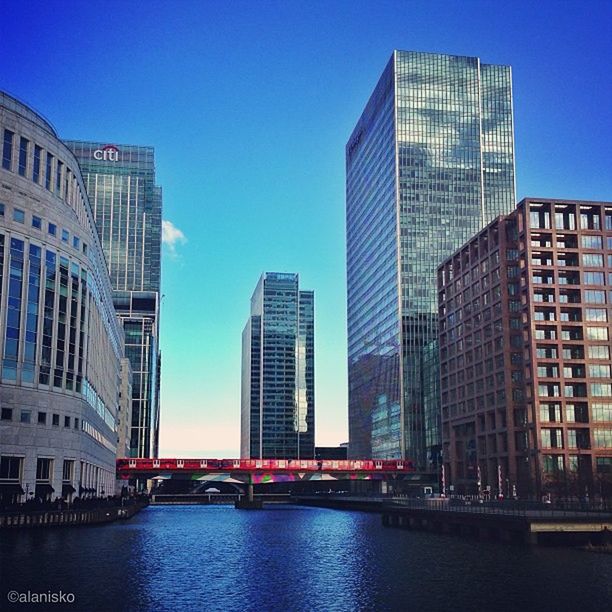 architecture, building exterior, built structure, city, waterfront, modern, office building, skyscraper, clear sky, water, tall - high, building, blue, tower, river, reflection, urban skyline, city life, cityscape, financial district