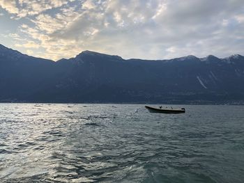 Scenic view of sea and mountains against sky