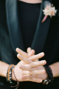 Midsection of woman holding flower