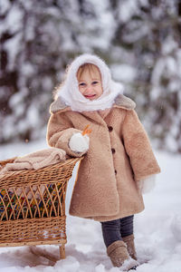 Portrait of cute girl standing in winter