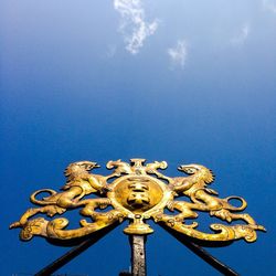 Low angle view of sculpture against blue sky