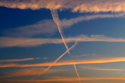 Low angle view of vapor trail against blue sky