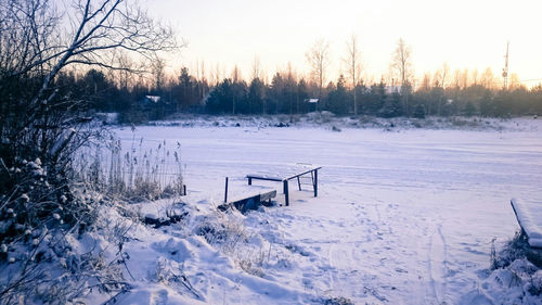 Snow covered landscape at sunset