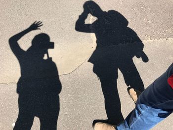 Shadow of people on road