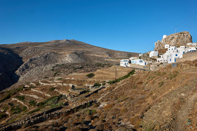 Panoramic view of buildings against clear blue sky