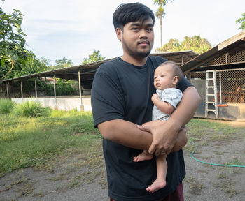 Father and son standing outdoors
