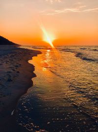 Scenic view of beach against sky during sunset