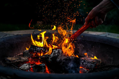 Close-up of hand holding burning at night