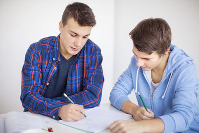 Teenage boys doing homework