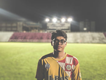 Portrait of young man standing on field