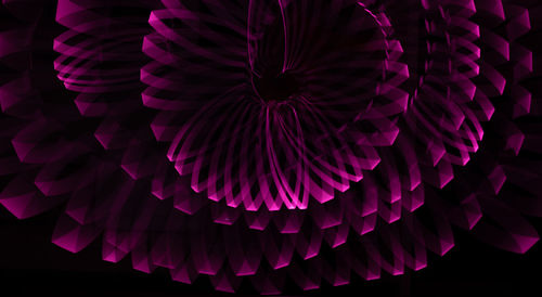 Low angle view of illuminated decoration hanging against black background