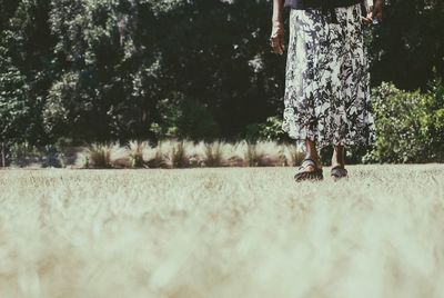 Woman standing on tree trunk