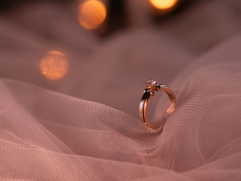 Close-up of wedding ring on textile