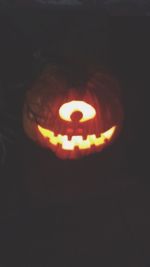 Close-up of illuminated pumpkin against black background