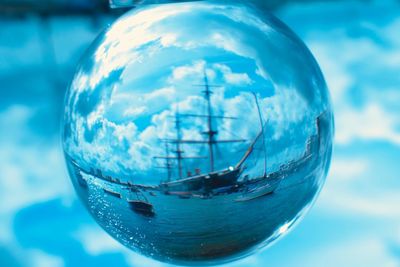 Close-up of bubbles in water against sky