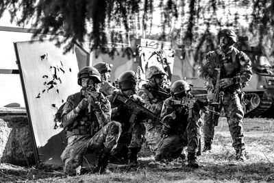 Rear view of people walking on field