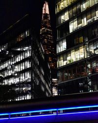 Low angle view of illuminated skyscraper at night