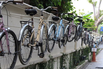 Bicycles parked on retaining wall in city