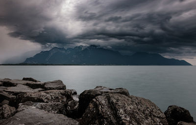 Rocks by sea against sky