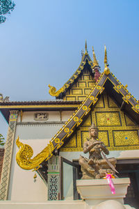 Low angle view of statue against building