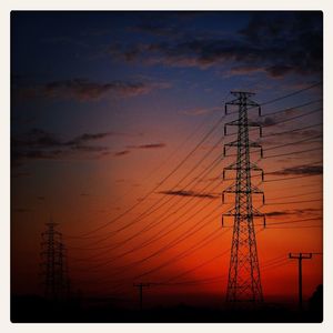 Low angle view of electricity pylon against sky