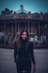 Portrait of smiling young woman standing outdoors