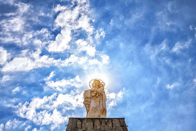 Low angle view of statue against blue sky