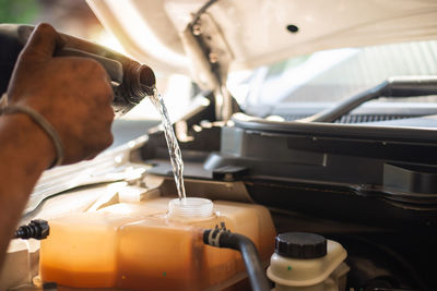 Midsection of man working in car