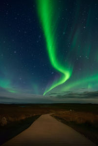 Scenic view of aurora borealis against sky at night