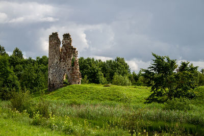Old ruin on field against sky