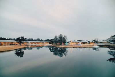 Reflection of trees in lake against sky