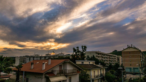 Low angle view of building against cloudy sky