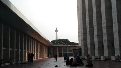 People walking in front of building