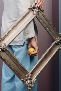 Midsection of woman holding apple