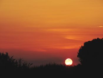 Scenic view of silhouette landscape against romantic sky at sunset