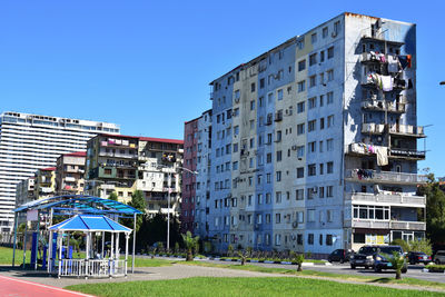 Buildings against clear blue sky in city