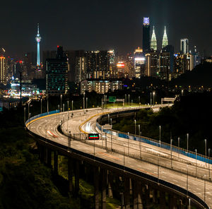 Illuminated bridge over river at night