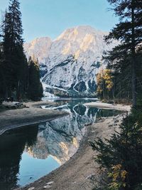 Scenic view of lake by mountains against sky