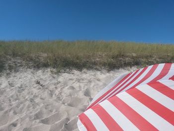 Scenic view of beach against clear blue sky