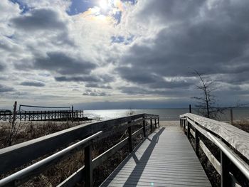 Pier over sea against sky