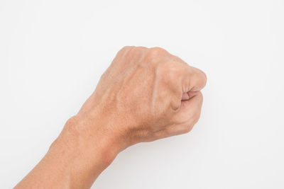Close-up of human hand against white background