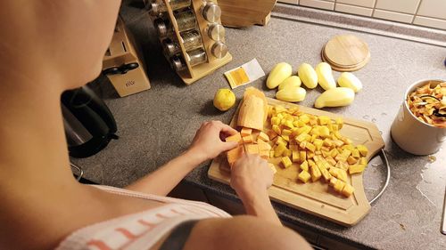 High angle view of woman preparing food on cutting board