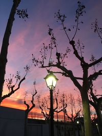 Low angle view of street light against cloudy sky