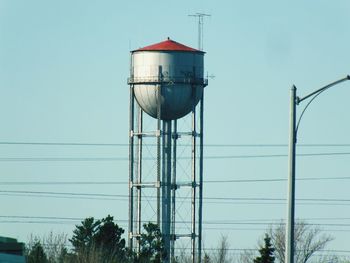 Low angle view of power lines against blue sky