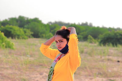 Young woman standing on field