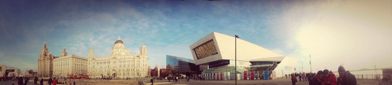 building exterior, architecture, built structure, sky, large group of people, men, person, lifestyles, cloud - sky, city, leisure activity, cloud, city life, outdoors, sunlight, tourist, building, day, travel destinations