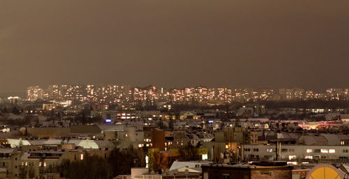 High angle view of illuminated buildings against clear sky at night