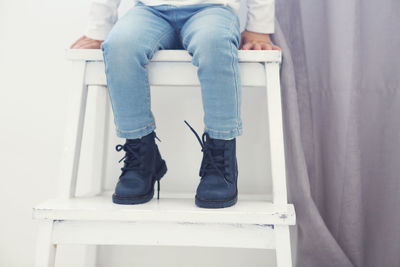 Low section of woman sitting on seat